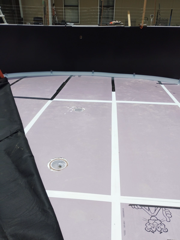 Floor padding laid out inside an above-ground pool wall