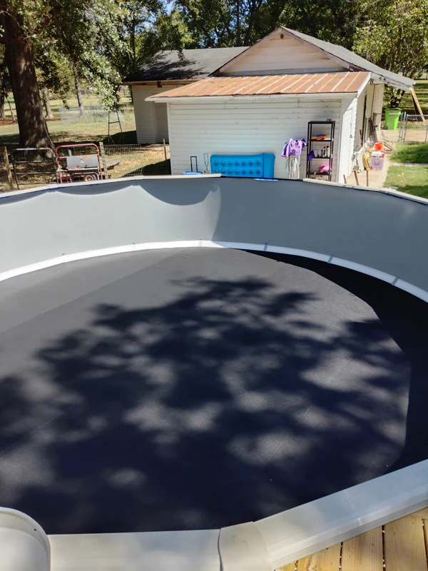 Above-ground pool filling over a new dark liner