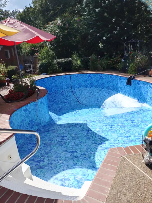 Freeform pool filling with water over a new patterned liner