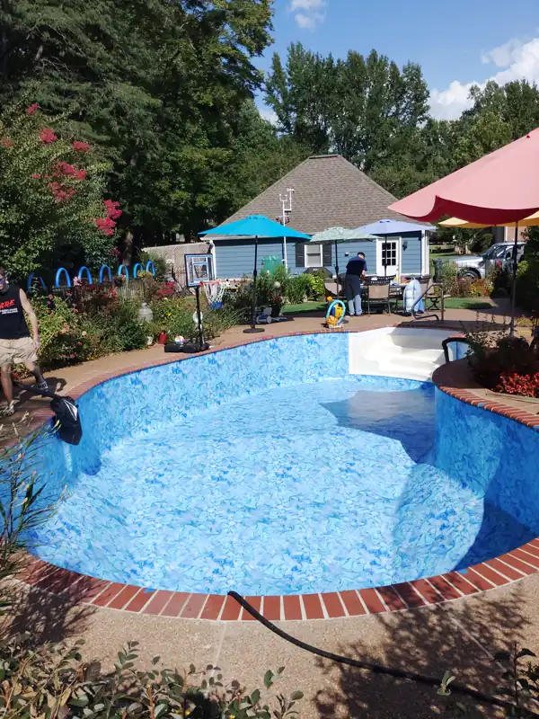 Freeform inground pool with a new patterned liner and brick coping